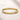 ENVYONE 18K Gold-Plated stainless steel contoured bangle displayed on a beige stone surface.