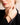 Closeup of a woman wearing an ENVYONE 18K Gold-Plated bangle sculptural bracelets with a black blazer.