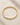 ENVYONE statement bangle crafted from 18K Gold-Plated stainless steel on a beige natural stone background.