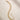 ENVYONE 18K Gold-Plated multi-strand link bracelet displayed on a beige stone surface.