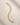ENVYONE 18K Gold-Plated multi-strand link bracelet displayed on a beige stone surface.