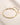 ENVYONE 18K Gold-Plated multi-strand chain bracelet displayed on a beige stone surface.