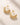 ENVYONE 18K Gold Plated hoop earrings on a textured beige surface