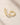 ENVYONE 18K Gold Plated huggie hoop earrings with sparkling zircon stones, displayed on a light beige stone surface.