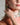 Closeup of a woman wearing ENVYONE 18K Gold Plated stainless steel sculptural hoop earrings.