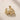 ENVYONE 18K Gold Plated premium stainless steel sculptural hoop earrings on a textured beige stone surface.