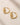 ENVYONE 18K Gold Plated premium stainless steel hoop earrings with a sculptural swirl design and hinged snap closure.