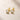 ENVYONE 18K Gold Plated 925 Sterling Silver stud earrings featuring brilliant round zircon stones in polished bezel settings, displayed on a light beige stone surface.