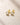 ENVYONE 18K Gold Plated 925 Sterling Silver stud earrings featuring brilliant round zircon stones in polished bezel settings, displayed on a light beige stone surface.