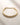 ENVYONE 18K Gold Plated stainless steel collar necklace with a bold rounded design displayed on textured beige stone.