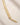 Closeup of an ENVYONE 18K Gold Plated sculptural collar necklace displayed on a textured neutral stone background.