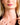 Closeup of a woman wearing an ENVYONE 18K Gold-Plated necklace with a small sculptural pendant featuring polished ribbed detailing.