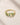 Closeup of ENVYONE 18K Gold-Plated 925 Sterling Silver adjustable ring with marquise and round green zircon stones.