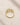 18K Gold Plated ENVYONE resizable ring with vibrant green zircon stones displayed on a textured beige stone surface.