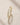 ENVYONE 18K Gold Plated eternity-style ring with brilliant white zircon stones displayed on a natural stone surface.