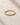 Closeup of an ENVYONE 18K Gold Plated eternity ring with round white zircon stones and a polished gold finish.
