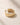 Closeup of an ENVYONE 18K Gold Plated adjustable wide-band ring with polished sculptural detailing.