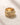 Close-up of an ENVYONE 18K Gold Plated stainless steel ring with intricate textured motifs and crystal detailing.