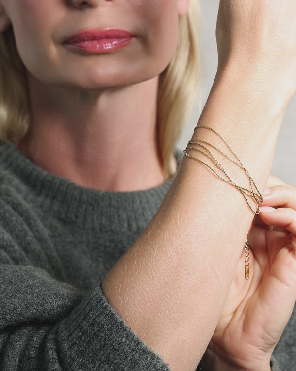 Video of a woman wearing an ENVYONE 18K Gold-Plated multi-strand chain bracelet.