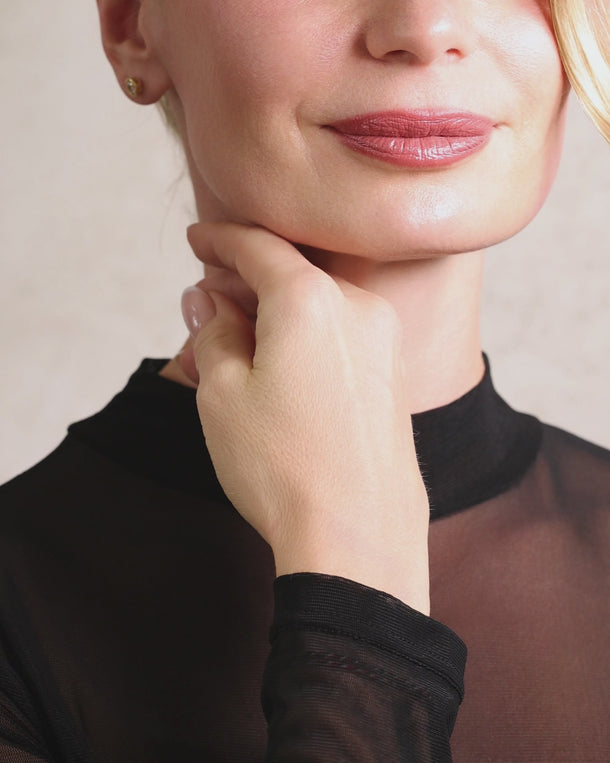 Video of a woman turning while wearing ENVYONE 18K gold-plated 925 sterling silver stud earrings with brilliant round zircon stones.