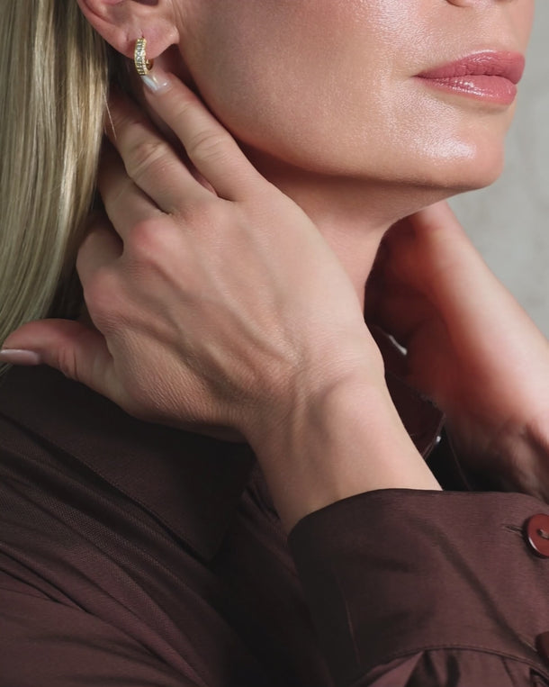 Detailed video of ENVYONE 18K Gold Plated zircon hoop earrings styled on a woman, highlighting their brilliant stone setting.