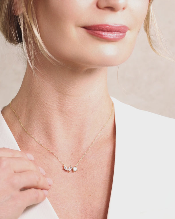 Woman wearing an ENVYONE 925 Sterling Silver necklace with 18K Gold Plating and brilliant white zircon stones in a close-up video.