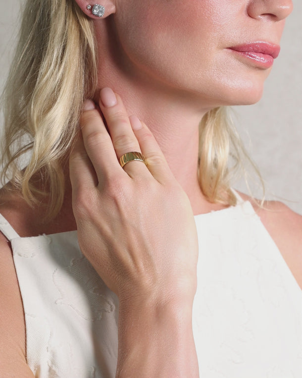 Closeup video of a woman wearing an ENVYONE 18K Gold Plated adjustable wide-band statement ring.