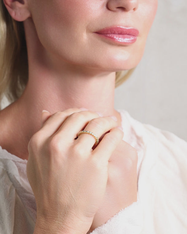 Video of woman styling an ENVYONE 18K Gold Plated zircon ring, designed to be worn alone or layered with other rings.