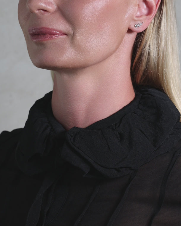 Video featuring a woman wearing ENVYONE 925 Sterling Silver leaf earrings with sparkling cubic zirconia stones.