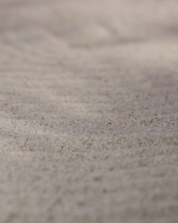 Product video showing an ENVYONE 18K Gold Plated statement ring landing on sand, highlighting its sculptural textured design.