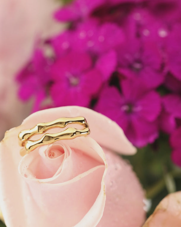 Closeup video of an ENVYONE 18K Gold Plated adjustable ring displayed on a rose.